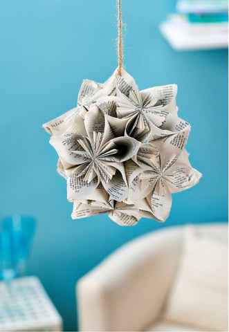 Upcycled hanging art in a baby's nursery made from book pages